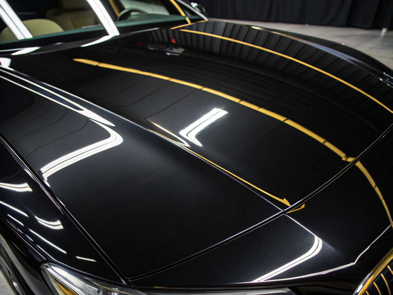 High-gloss luxury sports car hood reflecting precision detailing